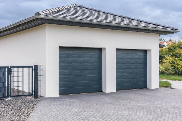 Two dark garage doors on a modern house.